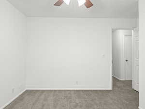 Bedroom with carpet floors and a ceiling fan
