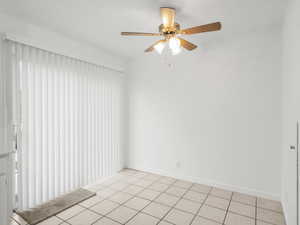 Dining room with ceiling fan and baseboards