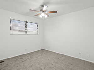 Carpeted bed room featuring baseboards and ceiling fan