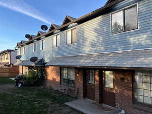 Back of house with brick siding and BRAND NEW vinyl siding