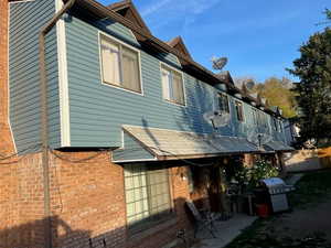 Rear view of property with brick siding and BRAND NEW vinyl siding