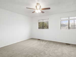 Bedroom with light carpet and ceiling fan