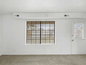 Living room with carpet floors and baseboards