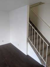 Stairs with wood finished floors and baseboards