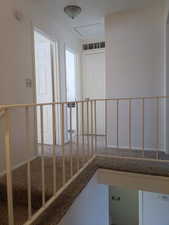Stairway featuring carpet flooring and baseboards