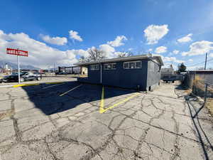 View of building exterior with uncovered parking