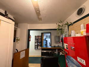 Office area featuring a textured ceiling