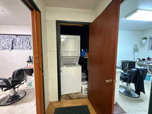 Corridor featuring stacked washer and clothes dryer