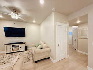 Living room featuring recessed lighting, a ceiling fan, and light wood finished floors