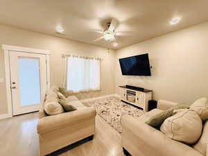 Living area featuring recessed lighting, light wood finished floors, and ceiling fan