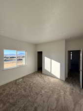 Bedroom 2 with carpet flooring, a textured ceiling, and a mountain view