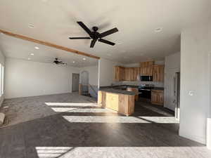 Kitchen/Living/Dining with arched walkways, open floor plan, appliances with stainless steel finishes, recessed lighting, and ceiling fan