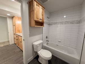 Basement Bathroom with  shower combination, vanity, and wood tiled floors