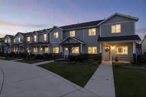 View of front facade with a fenced front yard, a residential view, and covered porch