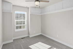 Unfurnished room featuring a ceiling fan and light carpet