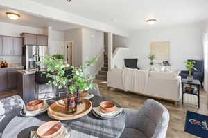 Living area with stairway and dark wood-style flooring