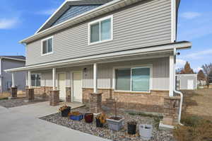 View of front of house featuring a porch and stone siding