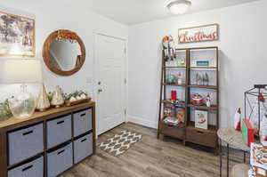 Foyer featuring light wood-style flooring and baseboards