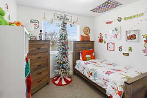 Bedroom featuring light carpet