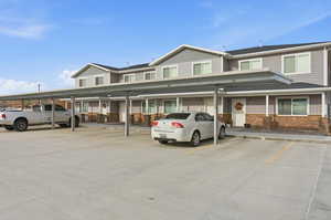 Traditional-style home featuring covered parking and stone siding