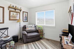 Sitting room with carpet flooring and baseboards