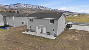 Back of property featuring a patio and a mountain view