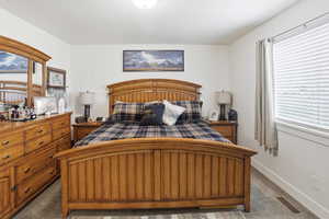 Carpeted bedroom featuring baseboards