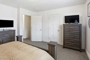 Carpeted bedroom with baseboards