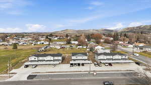 Aerial view of property's location featuring nearby suburban area and a mountain backdrop