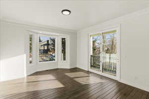 Unfurnished room featuring crown molding and wood-type flooring