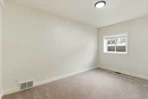 Carpeted empty room with baseboards