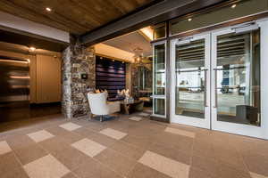 Interior space with elevator and french doors