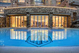 View of swimming pool featuring a patio area and a pool with connected hot tub