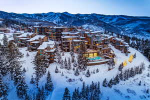 Snowy aerial view with a mountain view and a residential view