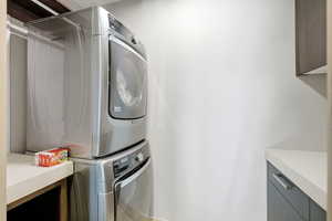 Laundry area featuring stacked washing machine and dryer