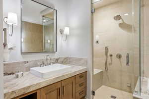 Full bathroom with vanity and a stall shower