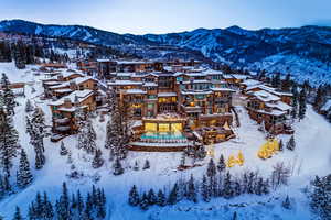 Snowy aerial view with a mountain view and a residential view
