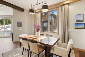 Dining room with wood finished floors and recessed lighting