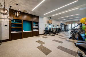 Gym featuring a chandelier