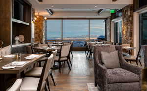 Dining room featuring hardwood / wood-style flooring, recessed lighting, and a water view
