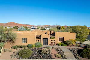 Adobe home featuring stucco siding and a mountain view