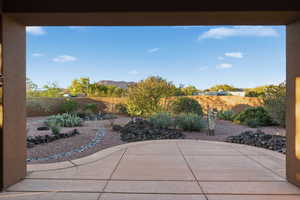 Fenced backyard featuring a patio and a mountain view