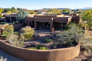 Pueblo-style house featuring stucco siding and a mountain view