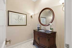 Bathroom with vanity and light marble finish floors