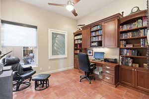 Office space featuring light tile patterned floors, a ceiling fan, and built in study area