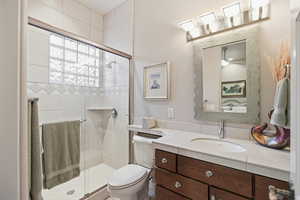 Bathroom featuring vanity and a stall shower