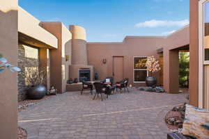 View of patio / terrace featuring exterior fireplace