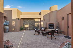 View of patio featuring an outdoor fireplace