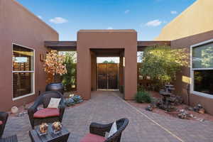 Doorway to property with stucco siding and a patio