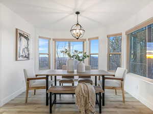 Dining room featuring light wood finished floors and a chandelier